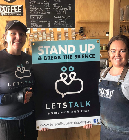 cafe supporters holding Lets Talk Australias poster